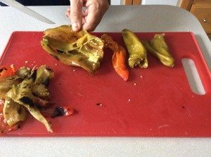 Peeling and seeding roasted chilis.